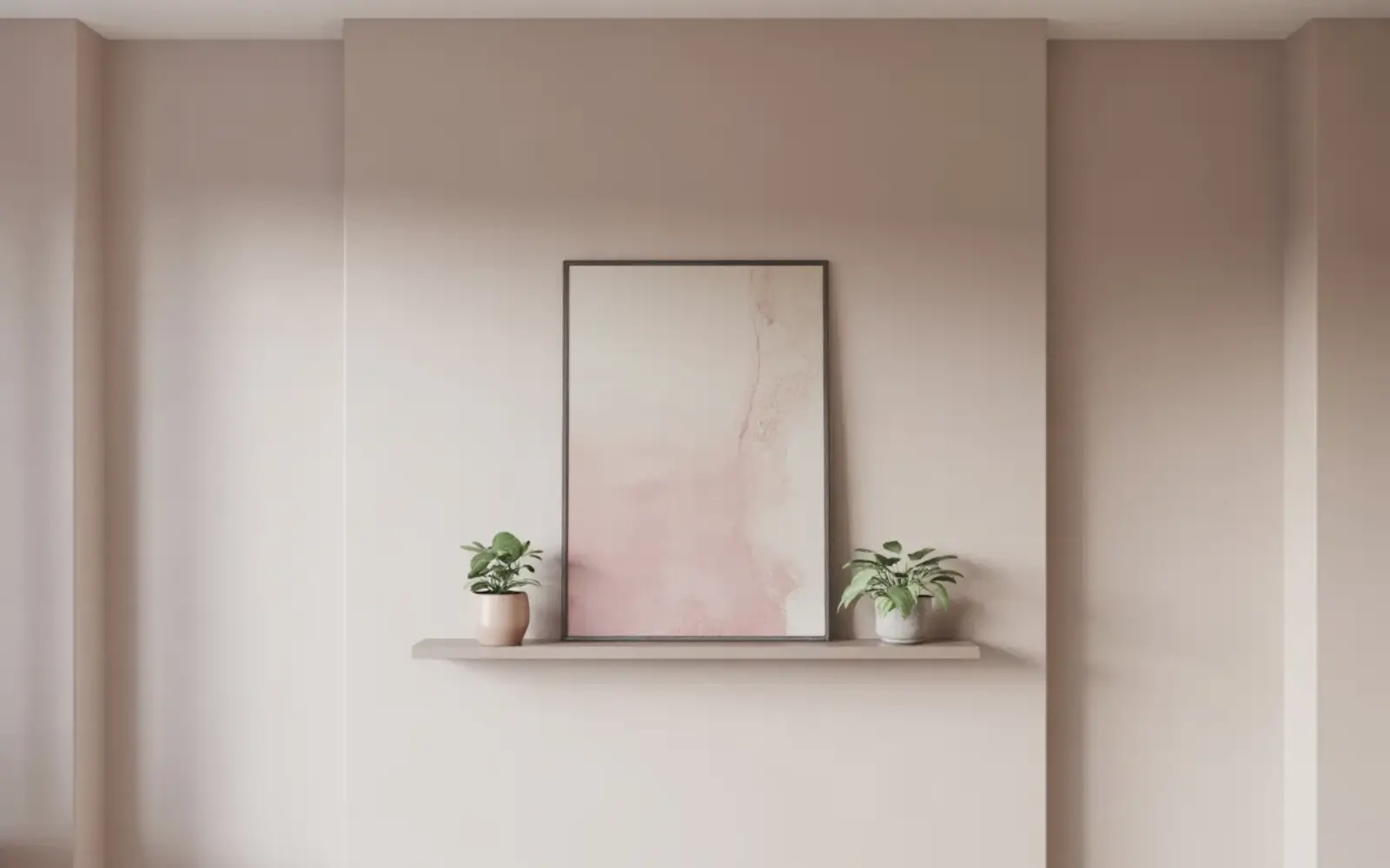 Feminine home office background wall with one large abstract print in soft pink and cream tones and two small plants on a floating shelf below.